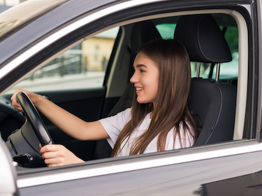 Teen driving a car