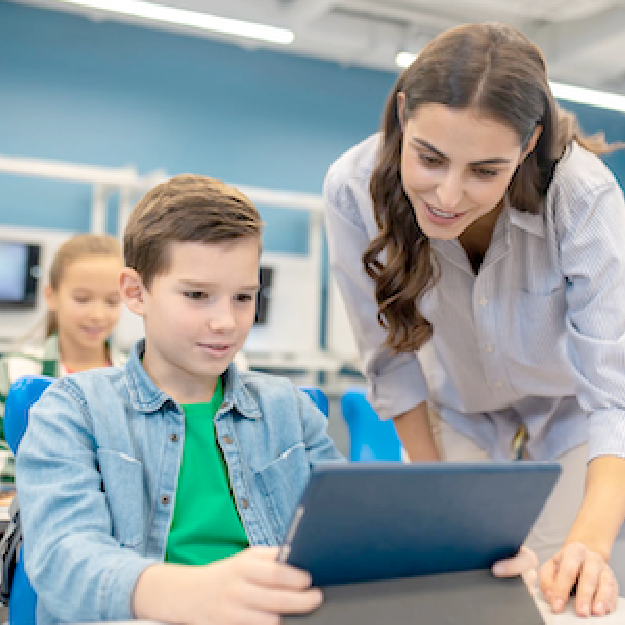 Teacher helping student using laptop