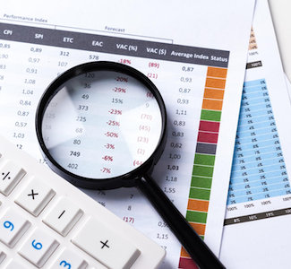 Close up of financial documents and a magnifying glass