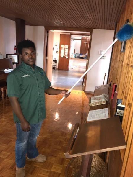 Student from Tradeworks dusting a wall