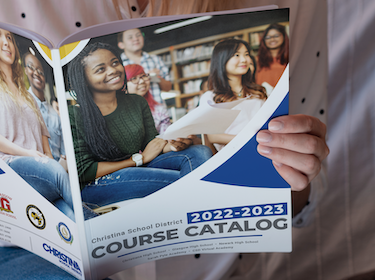   close up of student reading 2022-2023 course catalog