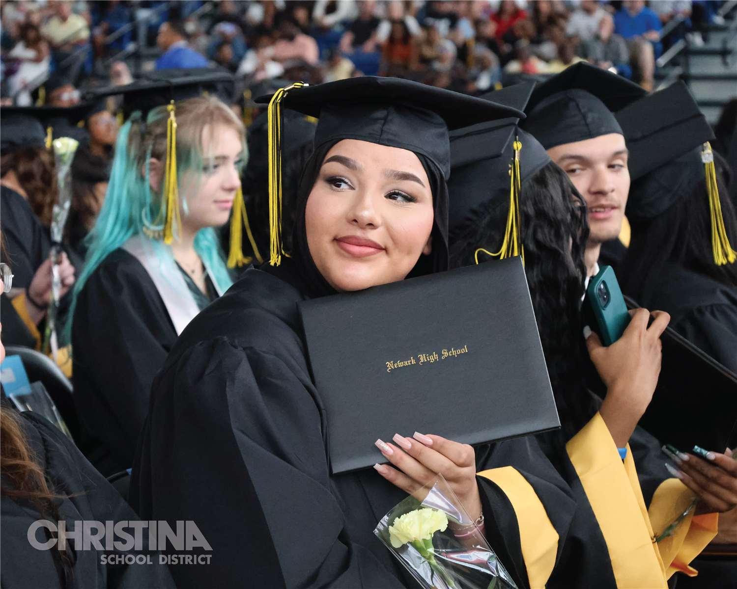 Photo of Newark HS student holding diploma