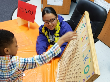 Students playing Plinko at Math Night 