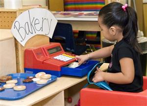 Preschooler playing as a bakery cashier 