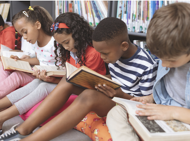  Group of children sitting on the floor reading books