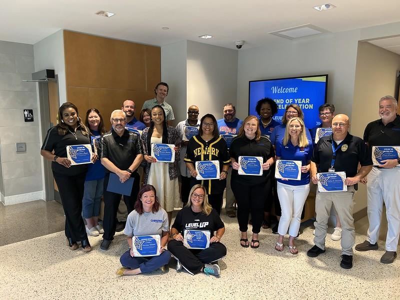 Photo of Christina Administrators at a conference showing awards.