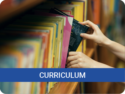 "Curriculum" close up of hand grabbing a book from a book shelf
